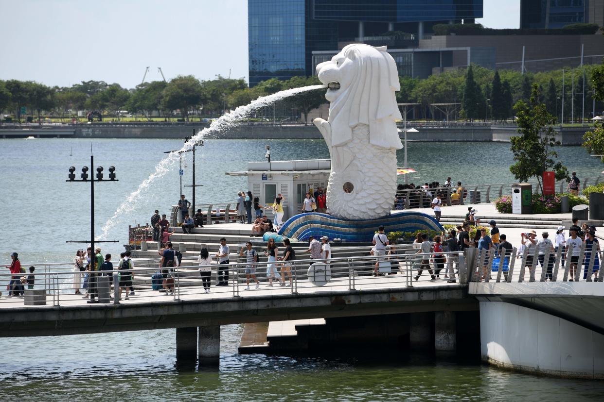 People gather on a jetty at Merlion Park in Singapore on February 5, 2020. (Photo by Roslan RAHMAN / AFP) (Photo by ROSLAN RAHMAN/AFP via Getty Images)