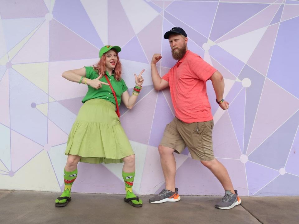 timothy and friend posing in front of the purple wall at disney world