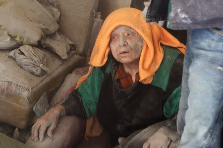 A woman, who survived an airstrike, sits amid the damage in the rebel held area of Old Aleppo. REUTERS/Abdalrhman Ismail