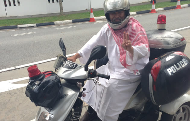 Zeng Guoyan turns up on a 'Police' bike complete in Arabic garb