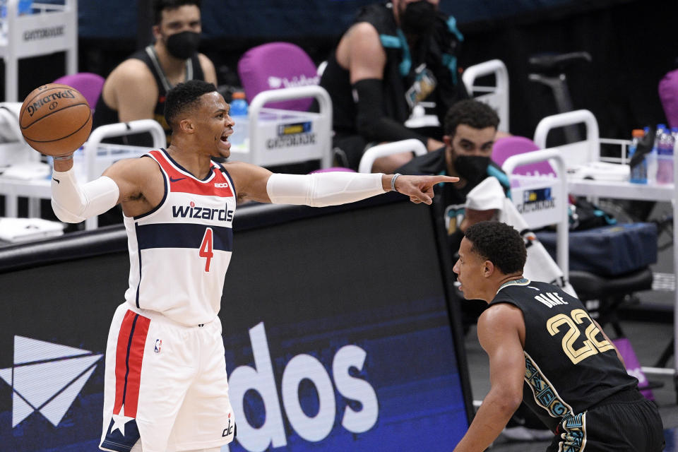 Washington Wizards guard Russell Westbrook (4) points during the first half of an NBA basketball game against Memphis Grizzlies guard Desmond Bane (22), Tuesday, March 2, 2021, in Washington. (AP Photo/Nick Wass)