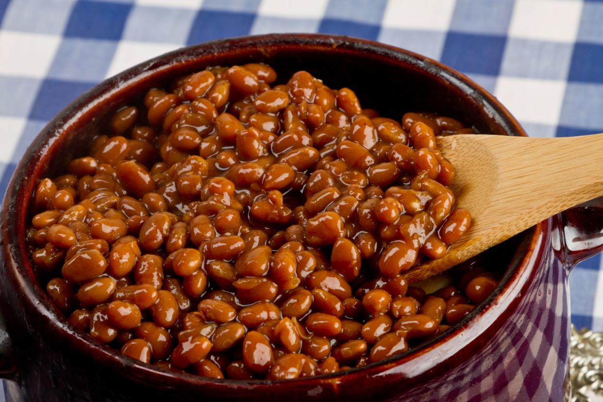 Crock pot full of baked beans on blue gingham