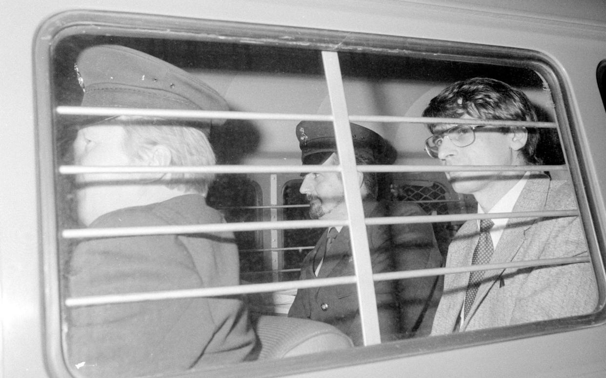 Serial killer Dennis Nilsen is escorted to a court hearing. He told police he killed as many as 15 people - PA