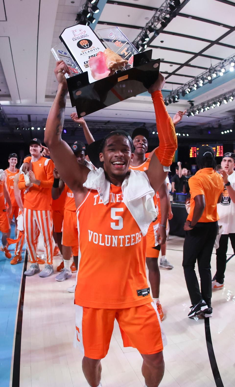 Tennessee guard Zakai Zeigler (5) carries the Battle 4 Atlantis championship trophy after the game against Kansas on Friday in the Bahamas at Imperial Arena.