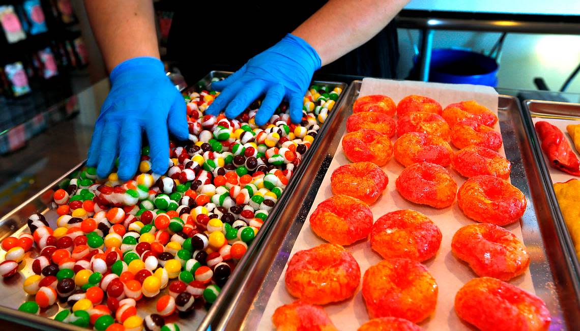 Sarra Hendrick, owner of JoJo’s Freeze Dried Goodies, separates pieces of stuck togehter candy that just finished about 96 hours in a freeze drier in the licensed commercial kitchen she installed in her Pasco home. Her business sells a wide variety of candy, fruit and other goodies.