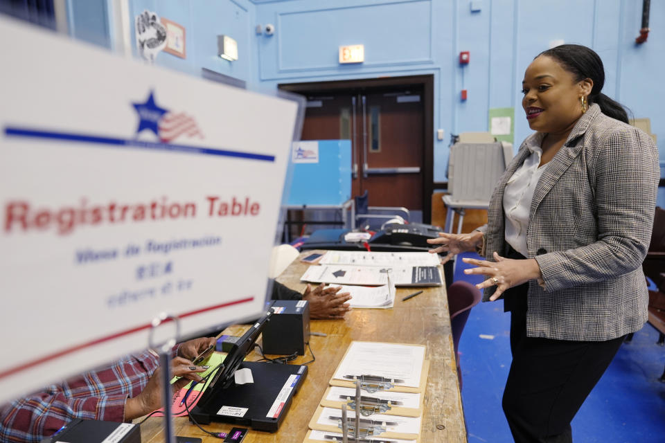 Democratic candidate Kina Collins who runs for Congress in the 7th District, talks with Early Voting Officials at Spencer Elementary Technology Academy before vote in Chicago, Tuesday, March 19, 2024. Illinois residents will vote Tuesday to narrow Democratic and GOP candidate fields in key U.S. House races. (AP Photo/Nam Y. Huh)