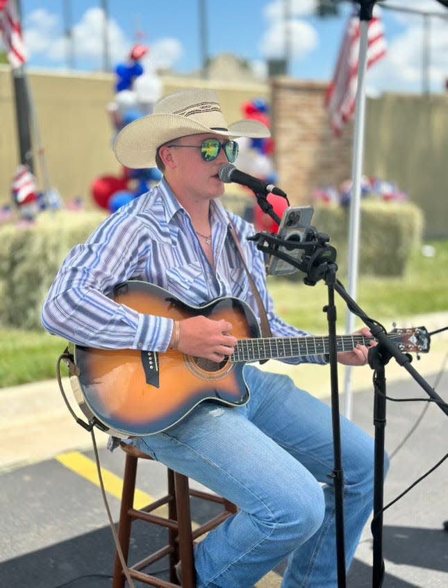 Labriers' son, Hayden, performs at the 60 years of Wolflin Square event held Friday as a give back to the community.