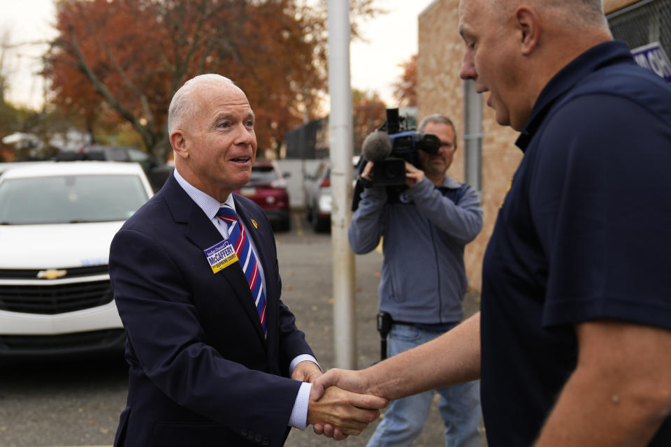 Daniel McCaffery, left, Democratic candidate for Pennsylvania Supreme Court judge, arrives at his polling place to vote in Philadelphia, Tuesday, Nov. 7, 2023. (AP Photo/Matt Rourke)