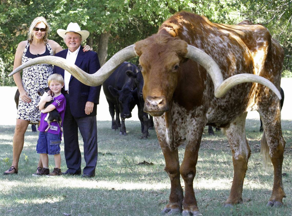 Jim Lane, wife Janet and son Jake (holding a farm dog) with longhorn Sancho, who had retired from the Fort Worth Herd, photographed on Sept. 7, 2012, near Azle.