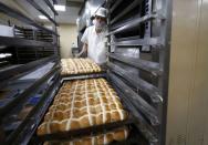 An employee works in the bakery at the Asda superstore in High Wycombe, Britain, February 8, 2017. REUTERS/Eddie Keogh