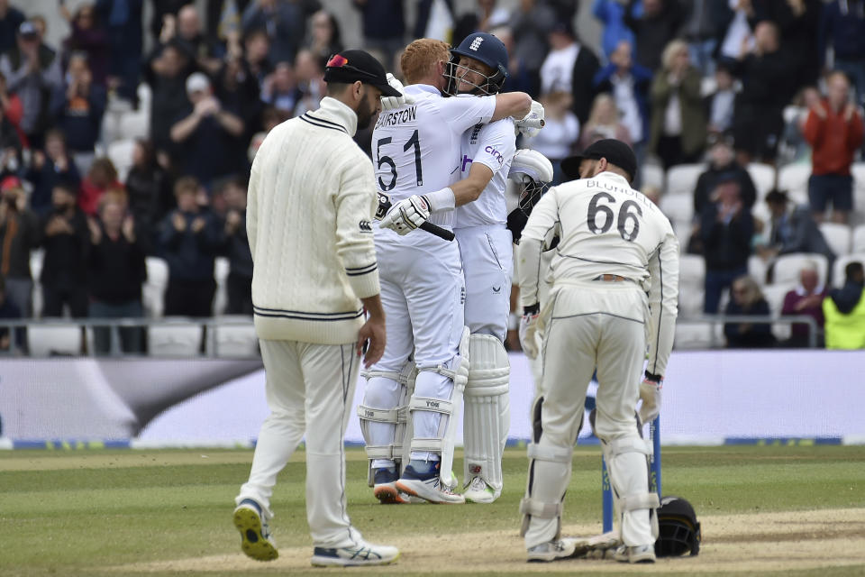 England's Joe Root, center right, hugs batting partner Jonny Bairstow to celebrate their win on the fifth day of the third cricket test match against New Zealand at Headingley in Leeds, England, Monday, June 27, 2022. (AP Photo/Rui Vieira)