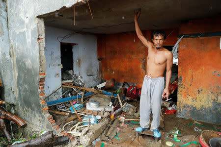 A man among the debris of a damaged house after a tsunami, in Sumur, Banten province, Indonesia December 26, 2018. REUTERS/Jorge Silva