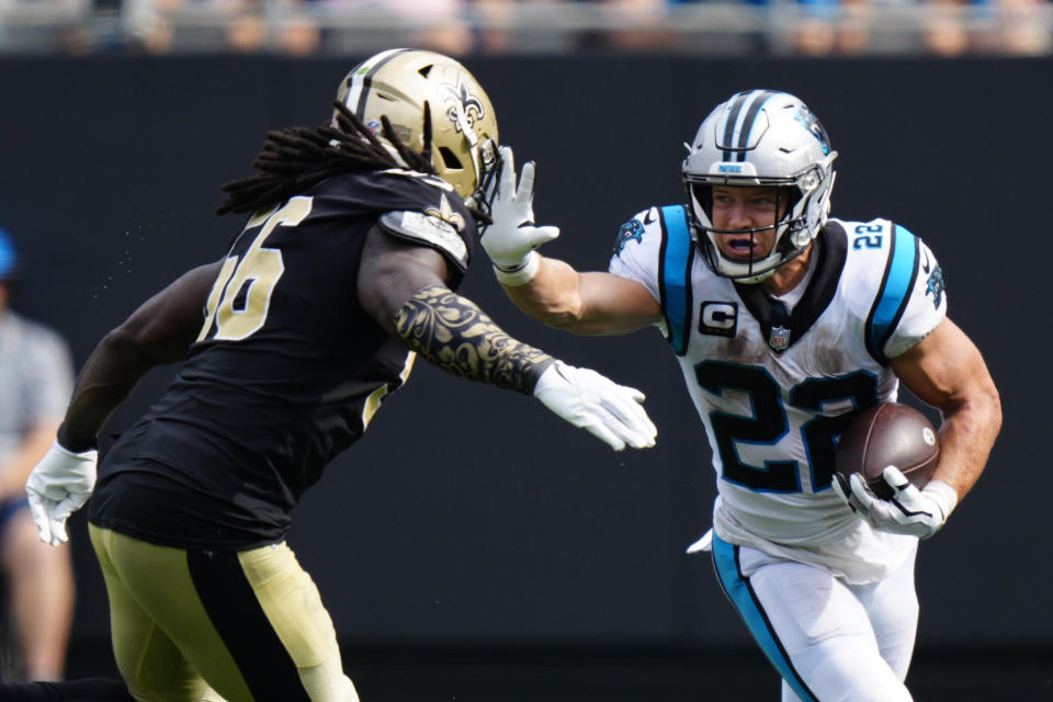 Carolina Panthers running back Christian McCaffrey pushes away from New Orleans Saints outside linebacker Demario Davis during the second half of an NFL football game Sunday, Sept. 19, 2021, in Charlotte, N.C. (AP Photo/Jacob Kupferman)