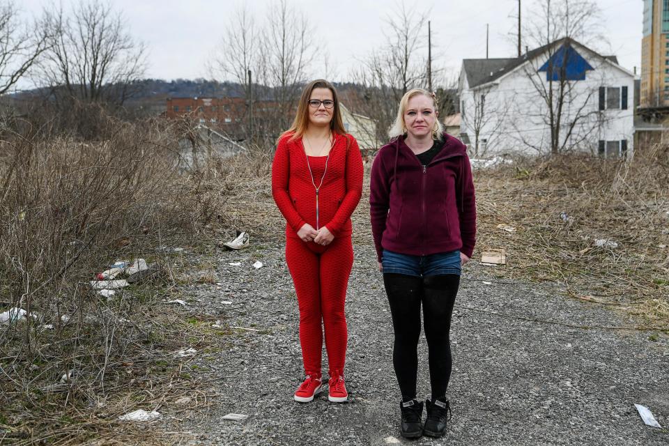 Samantha Ashe, left, and Joy Hanson March 2, 2021 at the debris-strewn vacant lot on Michael Street in Asheville where they say they were attacked and sexually assaulted in 2016.