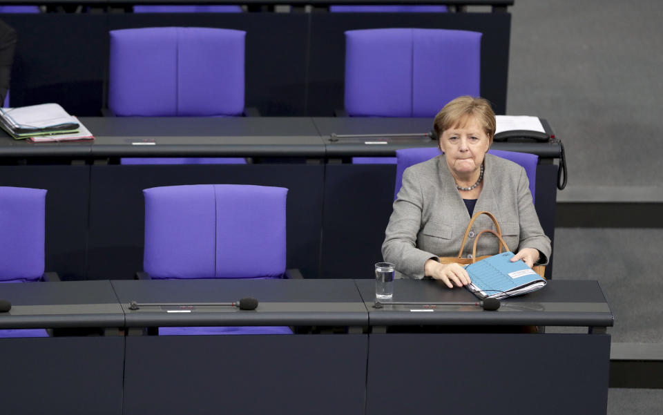German Chancellor Angela Merkel arrives for a Q&A event as part of a meeting of the German parliament, Bundestag, at the Reichstag building in Berlin, Germany, Wednesday, Dec. 18, 2019. (AP Photo/Michael Sohn)
