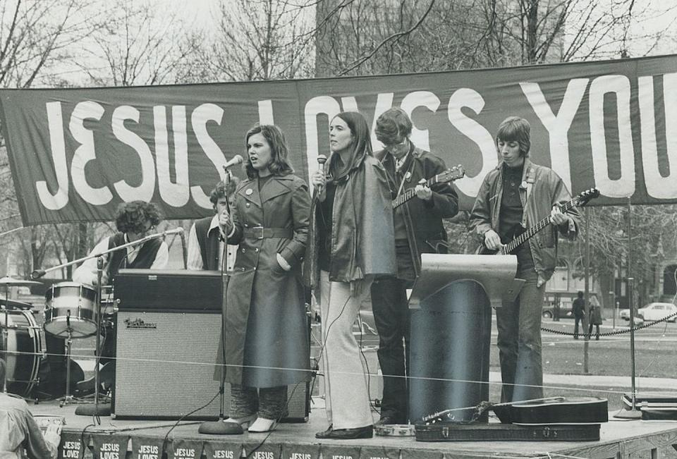 A ‘Jesus People’ rally in Toronto in 1971. <a href="https://www.gettyimages.com/detail/news-photo/the-message-is-jesus-announced-the-leader-of-the-band-at-news-photo/499307207?phrase=%22jesus%20people%22&adppopup=true" rel="nofollow noopener" target="_blank" data-ylk="slk:Dave Norris/Toronto Star via Getty Images;elm:context_link;itc:0;sec:content-canvas" class="link ">Dave Norris/Toronto Star via Getty Images</a>