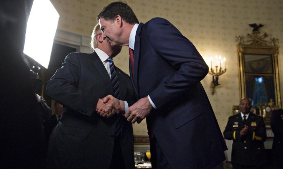 Donald Trump shakes hands with Jamese Comey at the White House on 22 January 2017.