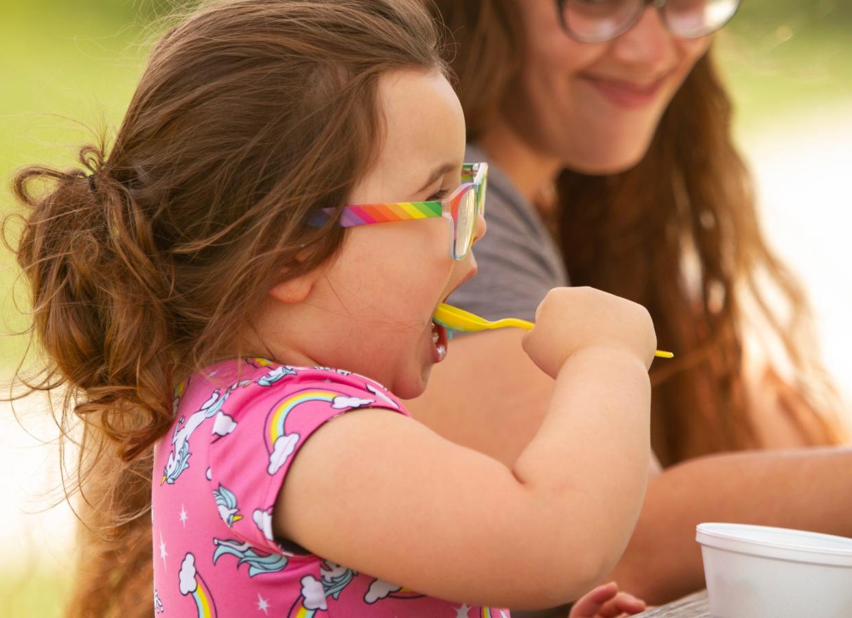 Four-year-old Kiera Timbehrski eats Blue Moon ice cream, accompanied by mom Jessica, at Cap'n Frosty Ice Cream in Hamburg Friday, July 2, 2021.