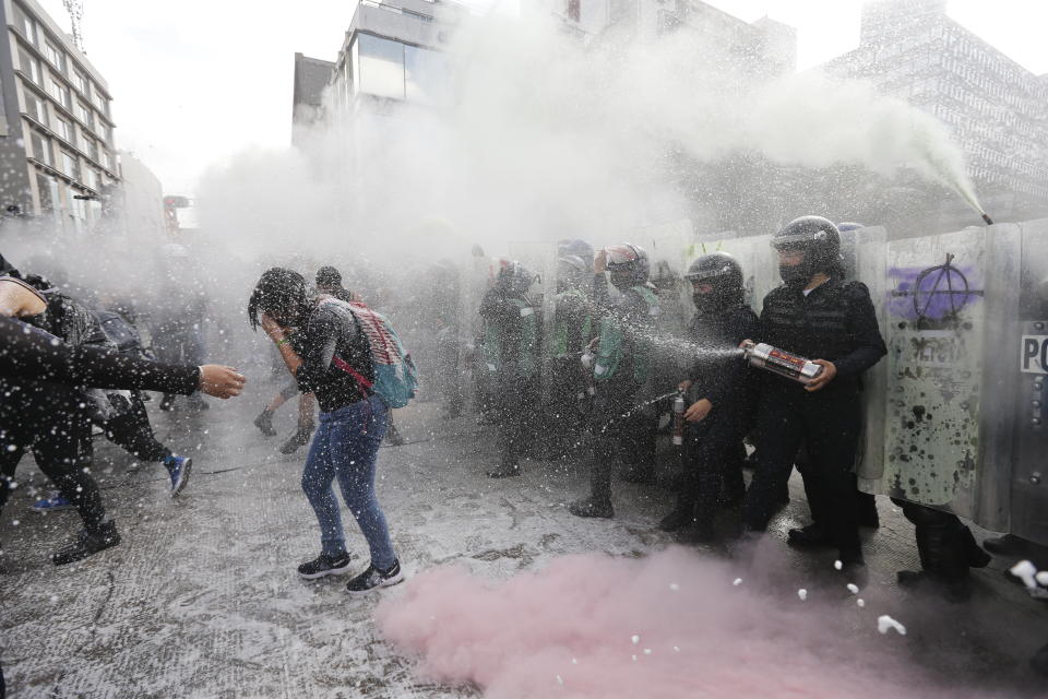 Demonstrators clash with riot police during a march supporting abortion rights in Mexico City, Monday, Sept. 28, 2020. (AP Photo/Marco Ugarte)