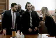 Defense attorneys Brian Horneyer, left, and Annie Legomsky, right, turn to their client defendant Thomas Kinworthy Jr., center, following a verdict in his first-degree murder trial Thursday, May 2, 2024, in the 22nd Circuit Court in St. Louis. Kinworthy was found guilty of first-degree murder and other counts in the death of St. Louis officer Tamarris Bohannon, 29, who was shot and killed and officer Arlando Bailey who was injured during a home invasion in August 2020. (Laurie Skrivan/St. Louis Post-Dispatch via AP, Pool)