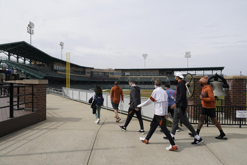 The Texas basketball team walks around the concourse at Victory Field at the NCAA college basketball tournament, Wednesday, March 17, 2021, in Indianapolis. (AP Photo/Darron Cummings)