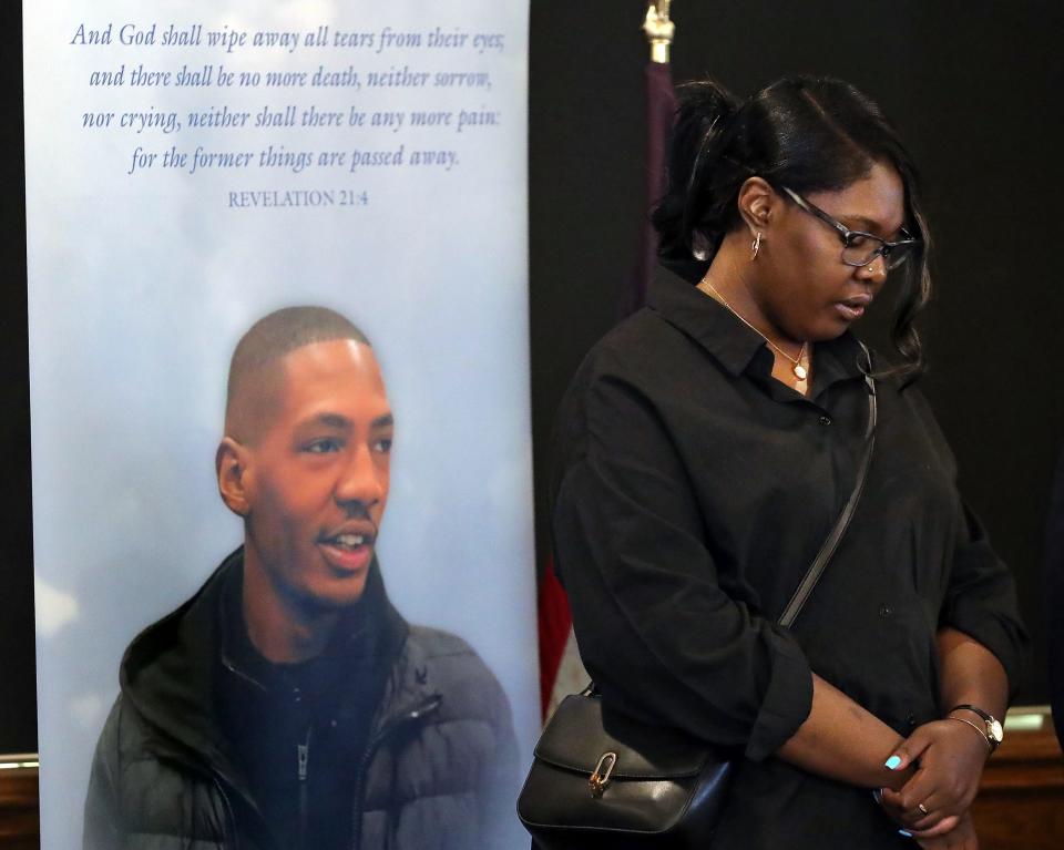 Jada Walker, sister of Jayland Walker, hangs her head as she listens to attorney Bobby DiCello speak during a newss conference Friday at the First Congregational Church of Akron,.