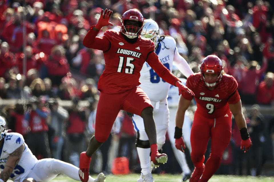 Louisville defensive lineman Kameron Wilson (15) celebrates after sacking Kentucky quarterback Devin Leary (13) during the first half of an NCAA college football game in Louisville, Ky., Saturday, Nov. 25, 2023. (AP Photo/Timothy D. Easley)