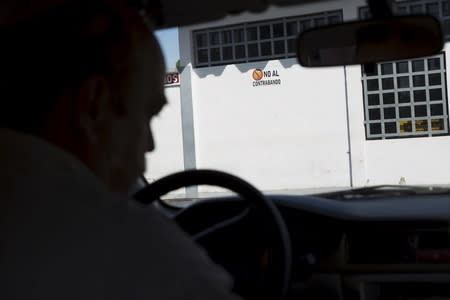 A placard reading, "No smuggling", is seen at a gas station near Rio Caribe a town near caribbean islands, in the eastern state of Sucre, Venezuela October 29, 2015. REUTERS/Carlos Garcia Rawlins