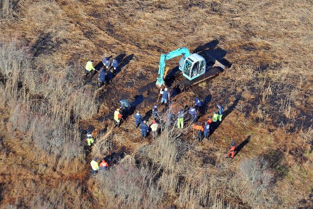 In this Dec. 8, 2011 photo, investigators use a backhoe to dig while searching for Shannan Gilbert's body in different sectors of a marsh area just east of Oak Beach, New York.