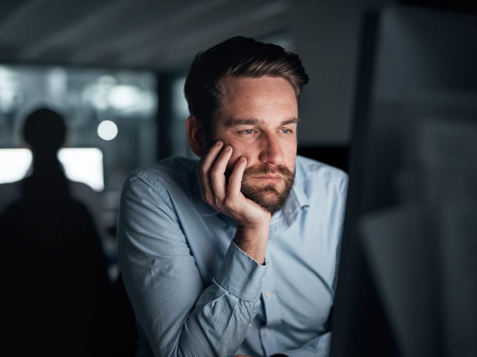 man on computer tired