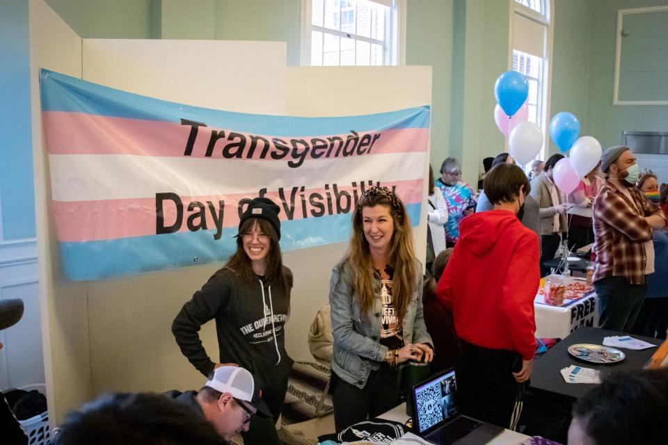 Event volunteers laugh with attendees during the 2022 Trans Day of Visibility event at National Avenue Christian Church.