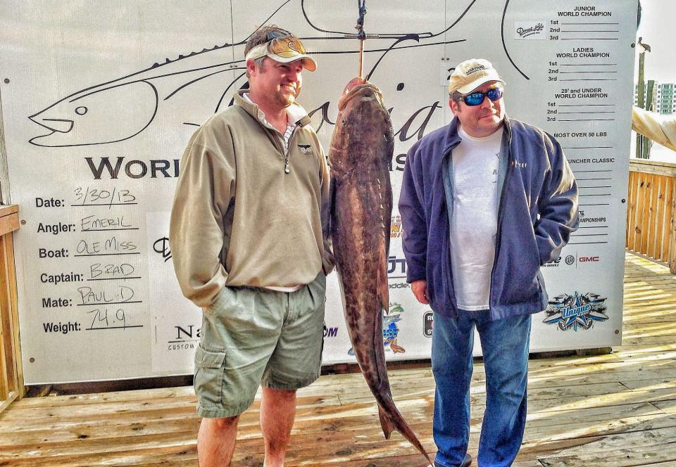 Emeril Lagasse, right, weighed in a fish during the 2013 World Cobia Championships at Harbor Docks.