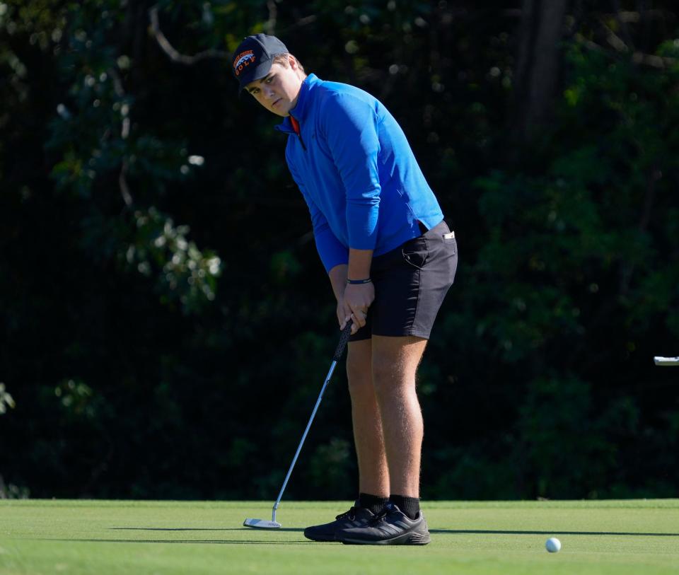 Spruce Creek's Gabriel Hull putts during the Five Star Conference boys golf tournament at Sugar Mill Country Club, Monday, Oct. 15, 2023.