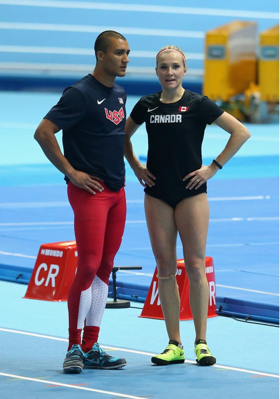 <p>Ashton Eaton (L) of the United States and Brianne Theisen Eaton of Canada talk during day one of the IAAF World Indoor Championships at Ergo Arena on March 7, 2014 in Sopot, Poland. (Photo by Julian Finney/Getty Images) </p>