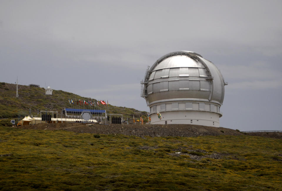 FILE - In this July 24, 2009 file photo, the Gran Telescopio Canarias, one of the the world's largest telescopes is seen at the Roque de los Muchachos Observatory in the Canary Island of La Palma, Spain. A leading Spanish official said Monday Aug. 5, 2019, that the consortium pushing to build a giant telescope in Hawaii amid continued protests by locals is planning to ask for a building permit for an alternative site in Spain's Canary Islands. The notification comes as Native Hawaiian protesters enter the fourth week of blocking construction of the telescope on a mountain they consider sacred. (AP Photo/Carlos Moreno, File)