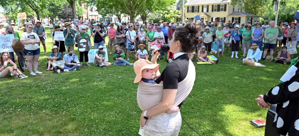 Episcopal minister Natalie Thomas carried her six-month- old daughter, Phoebe, as she spoke to demonstrators gathering on the Falmouth Village Green Saturday to protest the Supreme Court decision overturning the right to abortion.