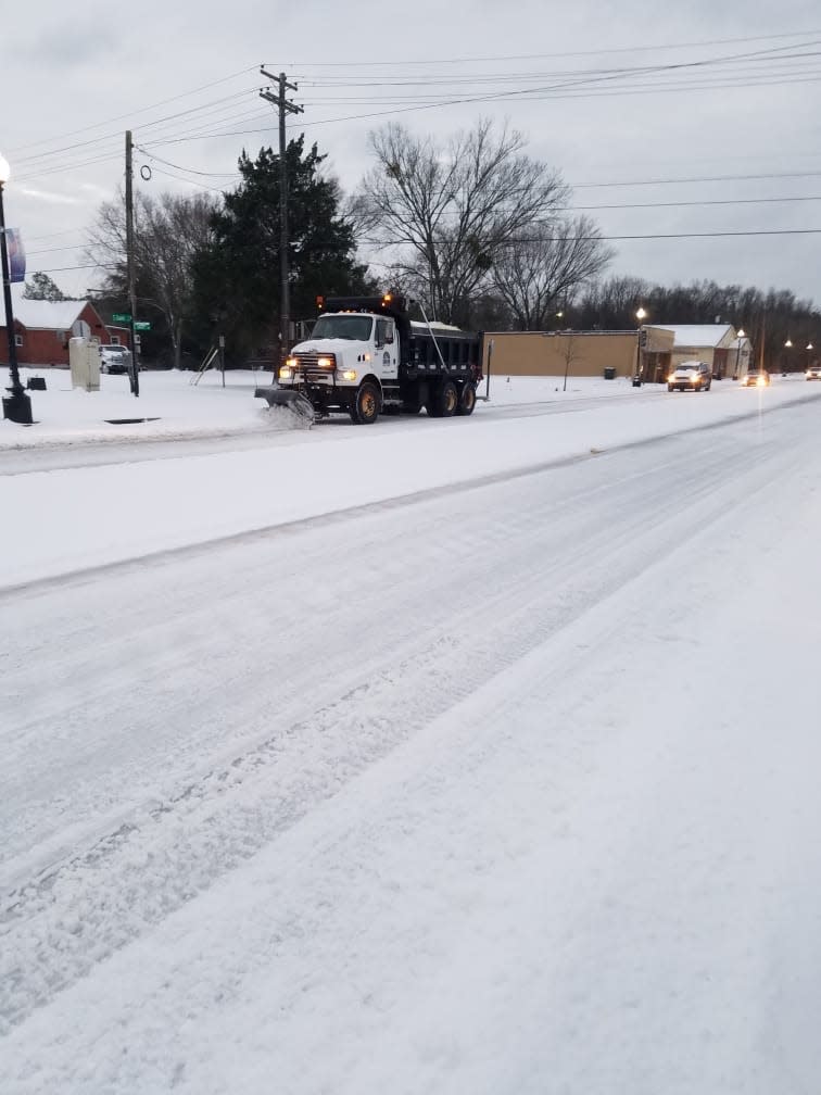 Crews were working to clear roads in Kinston early Saturday morning.