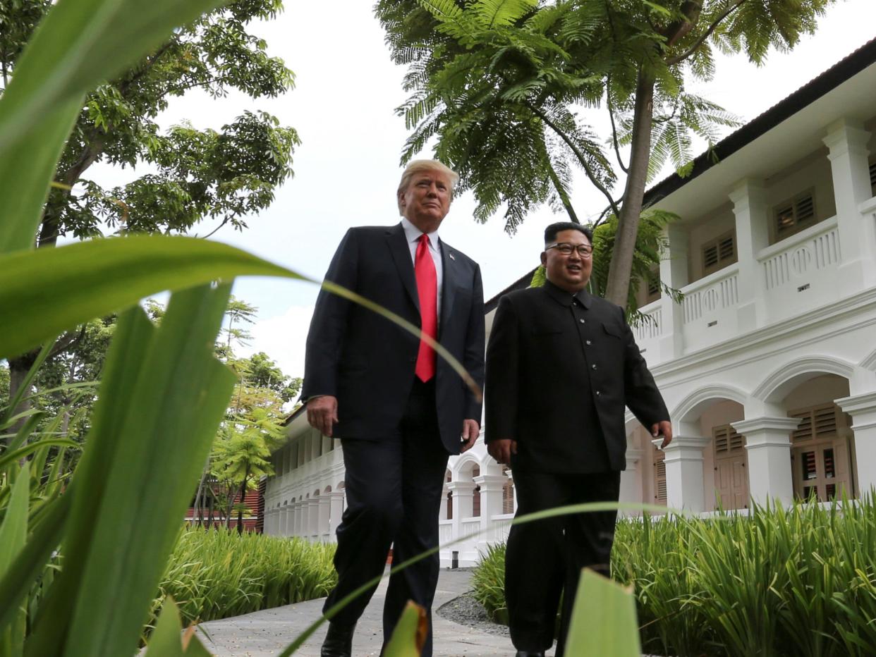 Donald Trump and Kim Jong-un walk together before their working lunch during their summit in Singapore: REUTERS/Jonathan Ernst