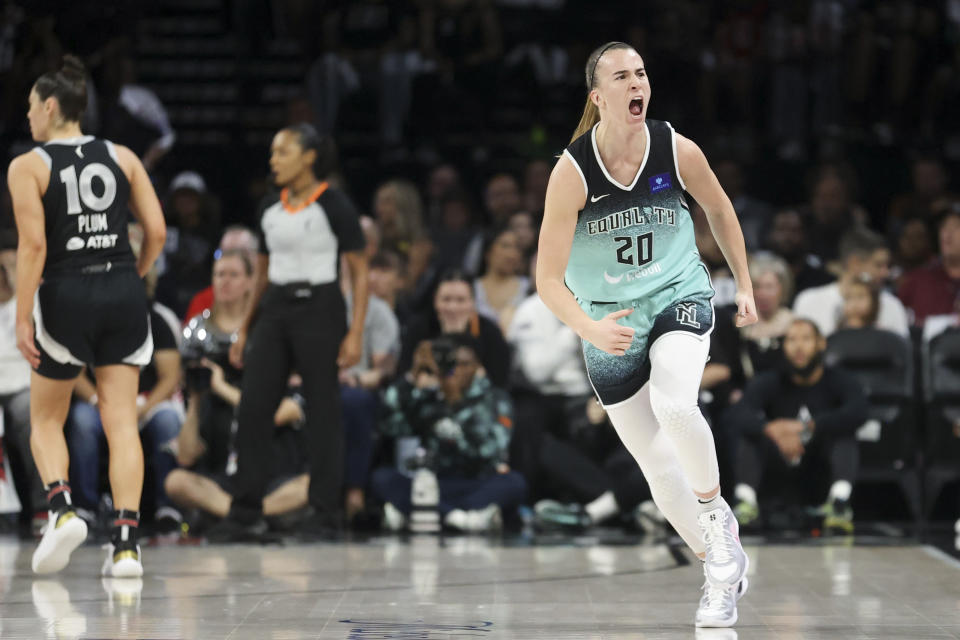 New York Liberty guard Sabrina Ionescu (20) reacts after a three-point basket in the first half of a WNBA semifinal basketball game Sunday, Oct. 6, 2024, in Las Vegas. (AP Photo/Ian Maule)