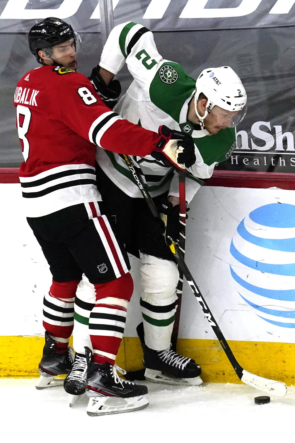 Dallas Stars defenseman Jamie Oleksiak, right, works for the puck against Chicago Blackhawks left wing Dominik Kubalik during the first period of an NHL hockey game in Chicago, Sunday, May 9, 2021. (AP Photo/Nam Y. Huh)