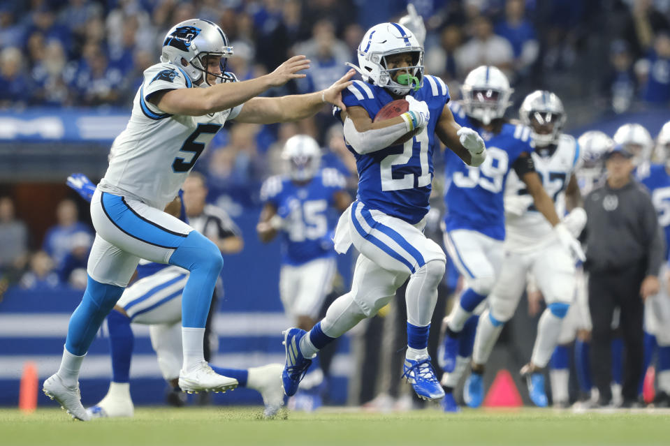 Indianapolis Colts running back Nyheim Hines (21) runs a punt back for a touchdown past Carolina Panthers punter Michael Palardy (5) during the first half of an NFL football game, Sunday, Dec. 22, 2019, in Indianapolis. (AP Photo/AJ Mast)