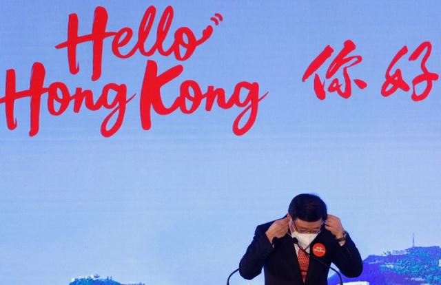 Hong Kong Chief Executive John Lee adjusts his protective mask after "Hello Hong Kong" campaign event to promote city tourism in Hong Kong
