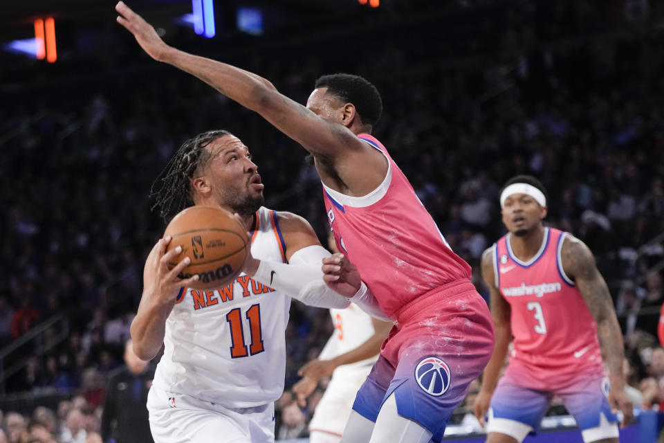 New York Knicks guard Jalen Brunson (11) drives against Washington Wizards guard Monte Morris, front right, during the first half of an NBA basketball game Wednesday, Jan. 18, 2023, at Madison Square Garden in New York. (AP Photo/Mary Altaffer)