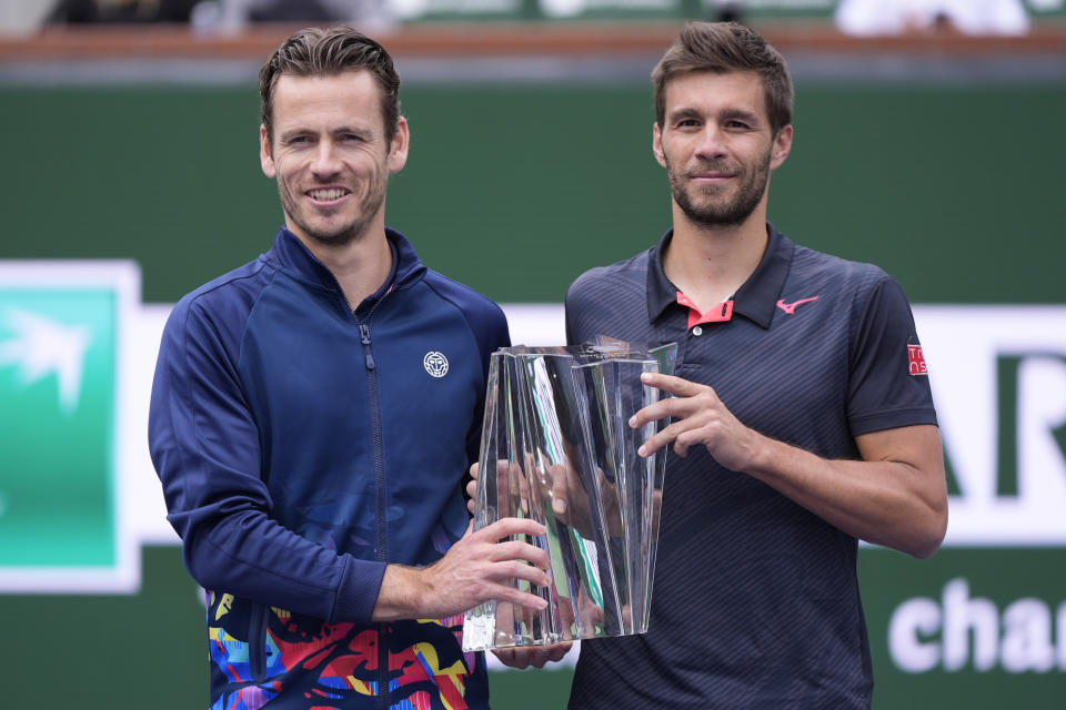 Nikola Mektic, of Croatia, right, and Wesley Koolhof, of the Netherlands, hold the trophy after defeating Marcel Granollers, of Spain, and Horacio Zeballos, of Argentina in the doubles final match at the BNP Paribas Open tennis tournament, Friday, March 15, 2024, in Indian Wells, Calif. (AP Photo/Mark J. Terrill)