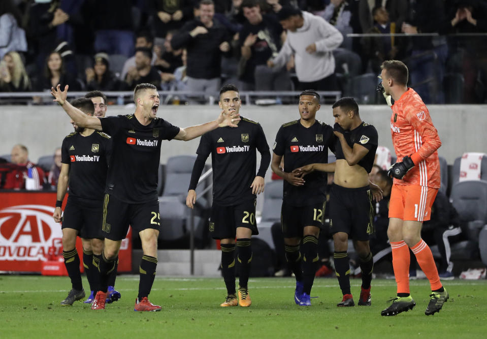 Los Angeles FC's Walker Zimmerman, second from left, raises his arms in celebration after scoring against Real Salt Lake during the second half of an MLS soccer match Saturday, March 23, 2019, in Los Angeles. (AP Photo/Marcio Jose Sanchez)