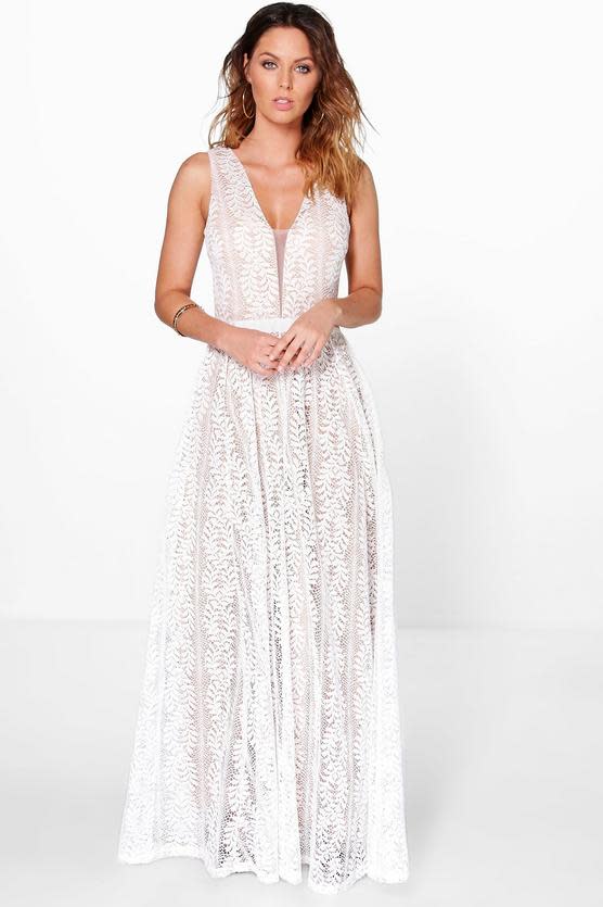 A model wears a white lace plunge neck maxi dress from Boohoo
