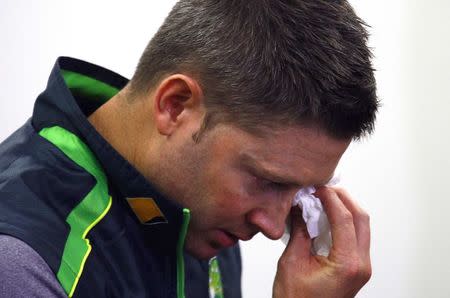 Australian cricket captain Michael Clarke wipes his eyes as he cries reading a tribute to Phillip Hughes, who died on Thursday, during a media conference at the Sydney Cricket Ground (SCG) November 29, 2014. REUTERS/David Gray