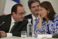 French President Francois Hollande (L) speaks with French Minister for Ecology, Sustainable Development and Energy Segolene Royal as they attend "The Climate Challenge and African solutions" event during the World Climate Change Conference 2015 (COP21) at Le Bourget, near Paris, France, December 1, 2015. REUTERS/Philippe Wojazer