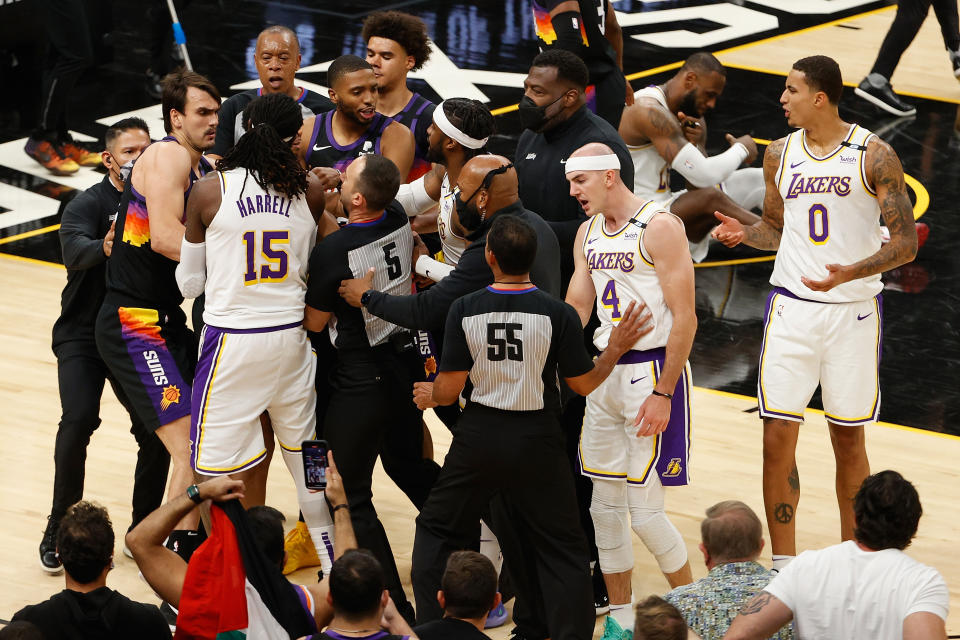 The Lakers' Montrezl Harrell, Alex Caruso and Wesley Matthews come together with the Suns' Dario Saric, Cameron Payne and Mikal Bridges in an altercation during the second half of Game 1 of their Western Conference first-round playoff series at Phoenix Suns Arena on May 23, 2021. ( Christian Petersen/Getty Images)