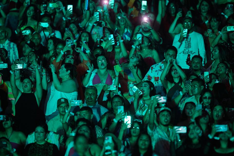 Bad Bunny fans record, dance and sing along with the music during Bad Bunny's World's Hottest Tour at Chase Field in Phoenix on Wednesday, Sept. 28, 2022.